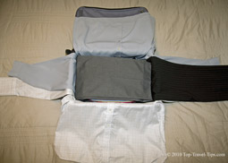 Trouser being wrapped around packing cube as part of bundle wrapping packing