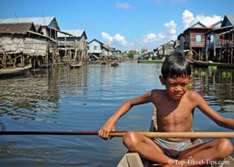 Simple ways to avoid single supplement Young boy in his boat in floating village Thailand