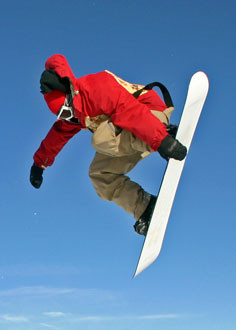 Types of skiing - Snowbarding jump Snowboarder jumping on his snowboard